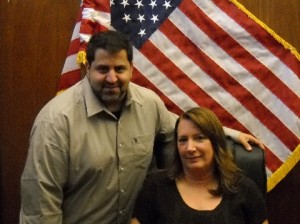 Photo of Anthony Toteda and Sheryl Luongo with an Amercian flag ebhind them