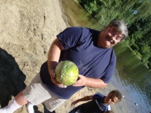 Man holding a ball next to a child
