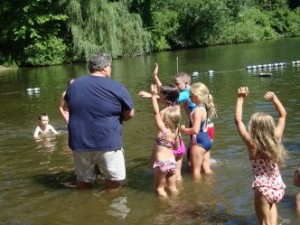 Adult and children playing in lake