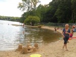 Sand castle and children swimming