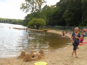Sand castle and children swimming