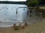 Sand castle and children swimming